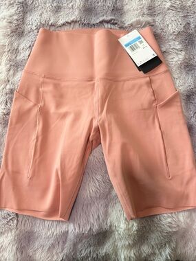 Nike Universa Coral color High-Rise Peach Bike Shorts with Side Pockets